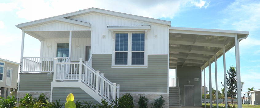 Exterior view of a manufactured home showcasing raised foundation and high-quality construction design